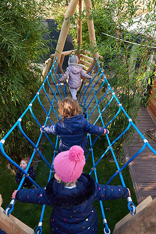 toddler at mini home nursery on a plank